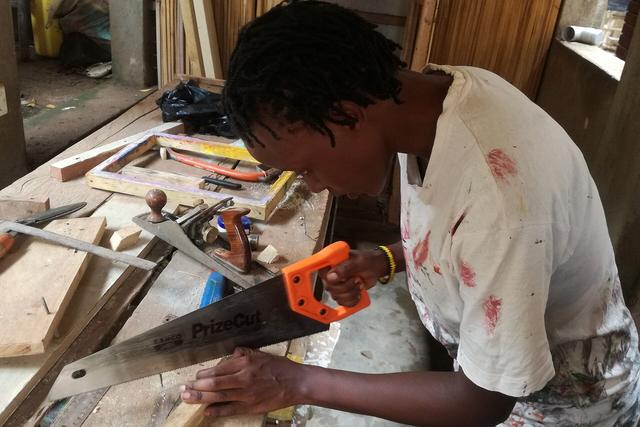 Carpenter marking and cutting a length of timber